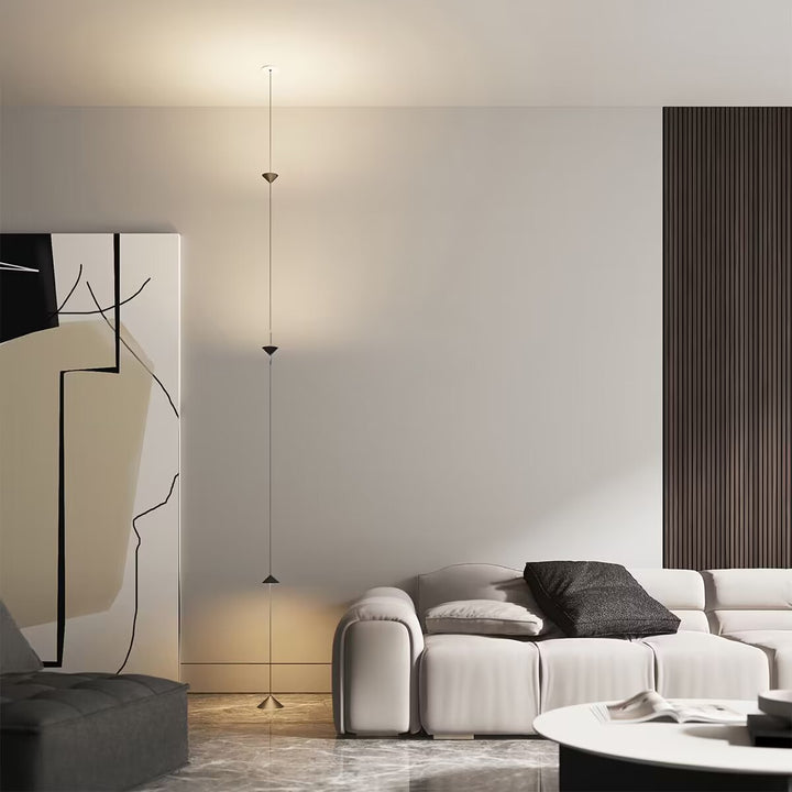 Hourglass Wall Lamp providing vertical ambient lighting in a modern living room.