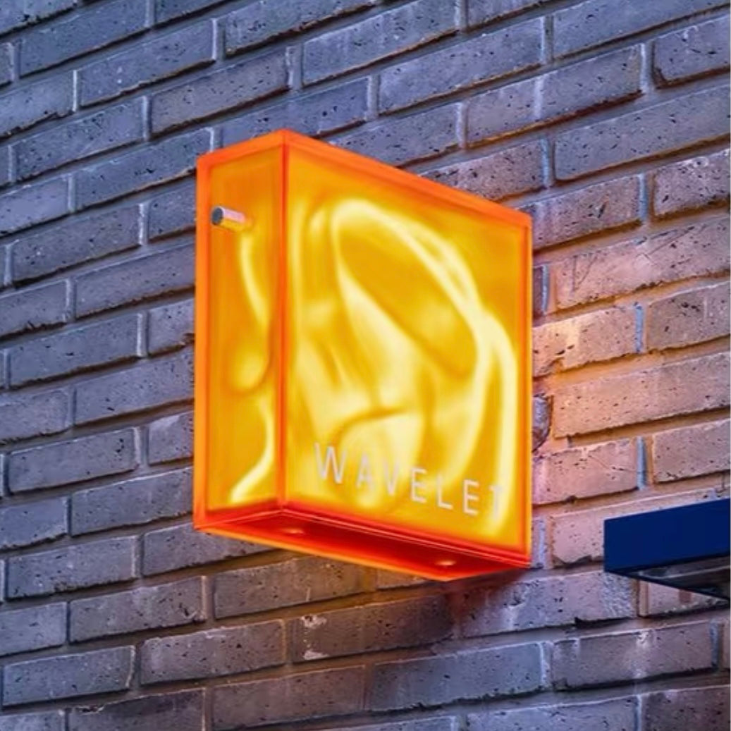 illuminated neon art box with acrylic enclosure mounted on brick wall for retail storefront display