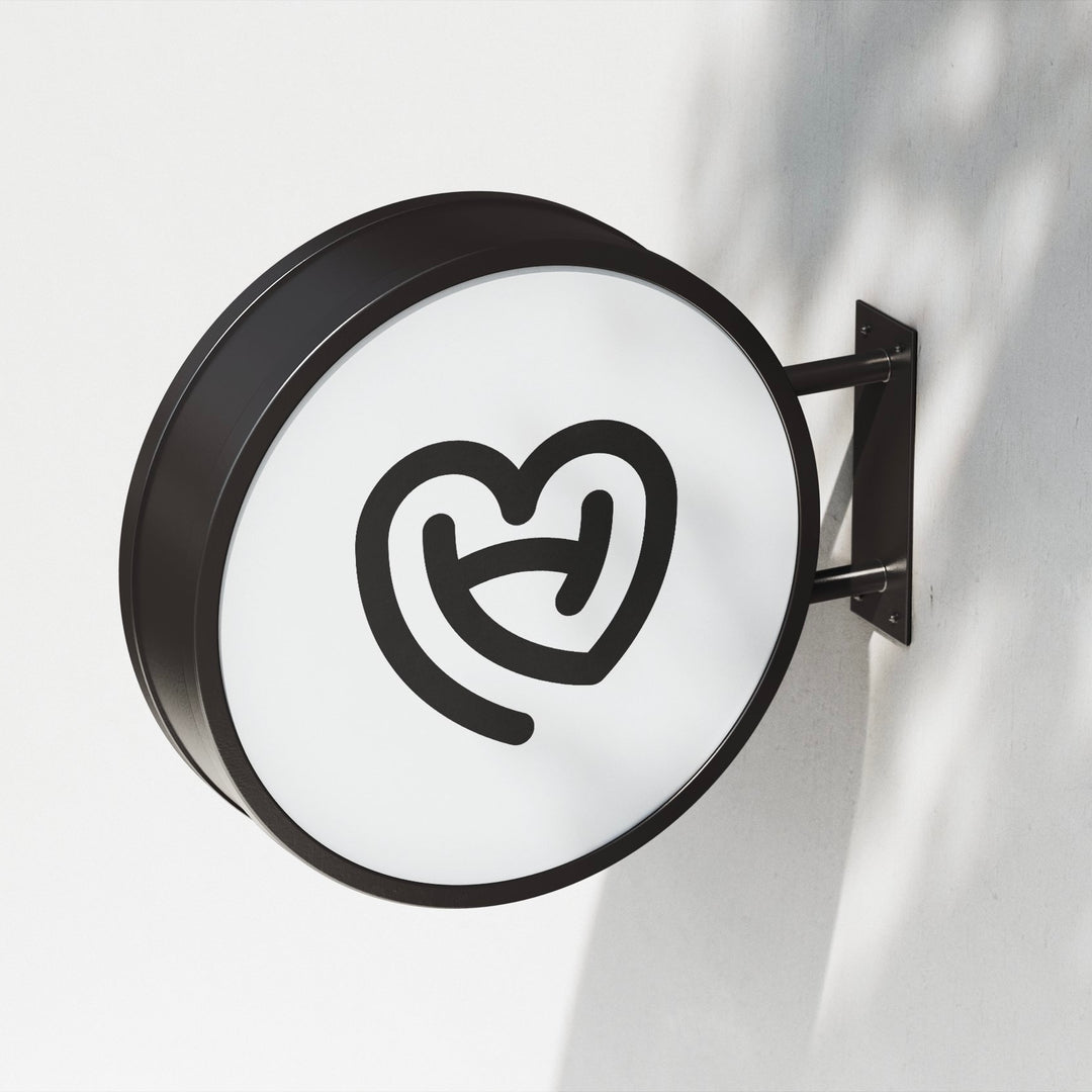 Illuminated round projecting blade sign wall mounted for retail storefront