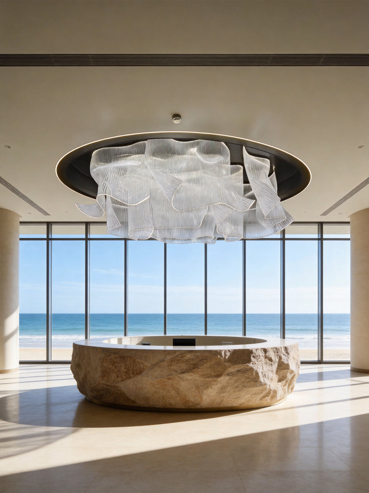 Infinity Waves Bespoke Lighting installed in a luxury coastal residence featuring a sculptural LED pendant light and modern architectural interior design.