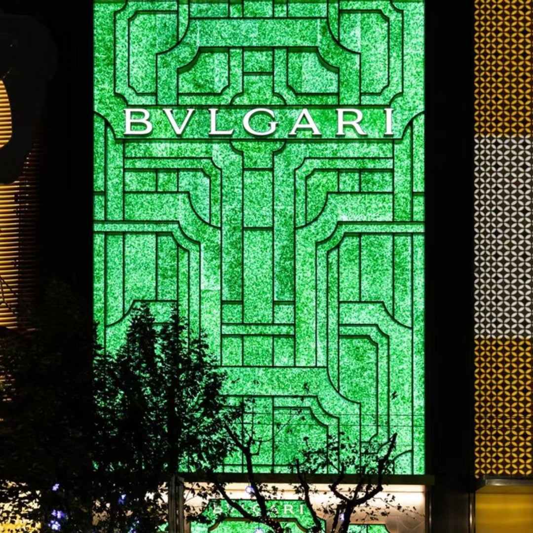 Jade glass feature wall creating a decorative architectural facade in a commercial space