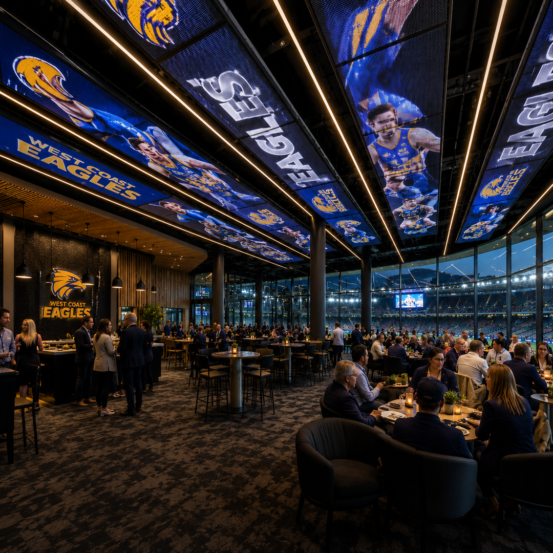 LED Mesh Ceiling Display installed in a stadium hospitality lounge featuring suspended architectural LED mesh panels displaying sports branding and digital content.