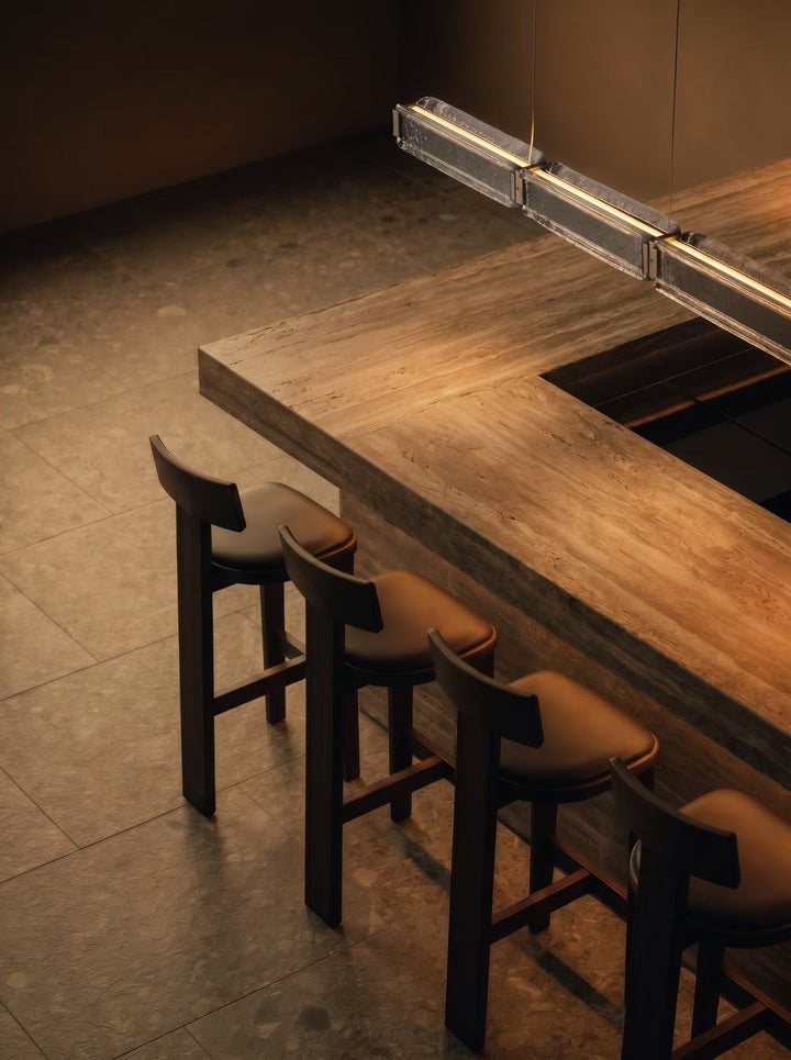 Close-up of Lucretia Arctic Linear LED Pendant Light installed above a dining table showcasing anti-glare architectural lighting and crystal-accented linear design.