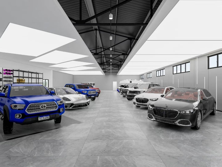 Lucretia LED stretch ceiling delivering even low-glare illumination across a multi-vehicle display area.