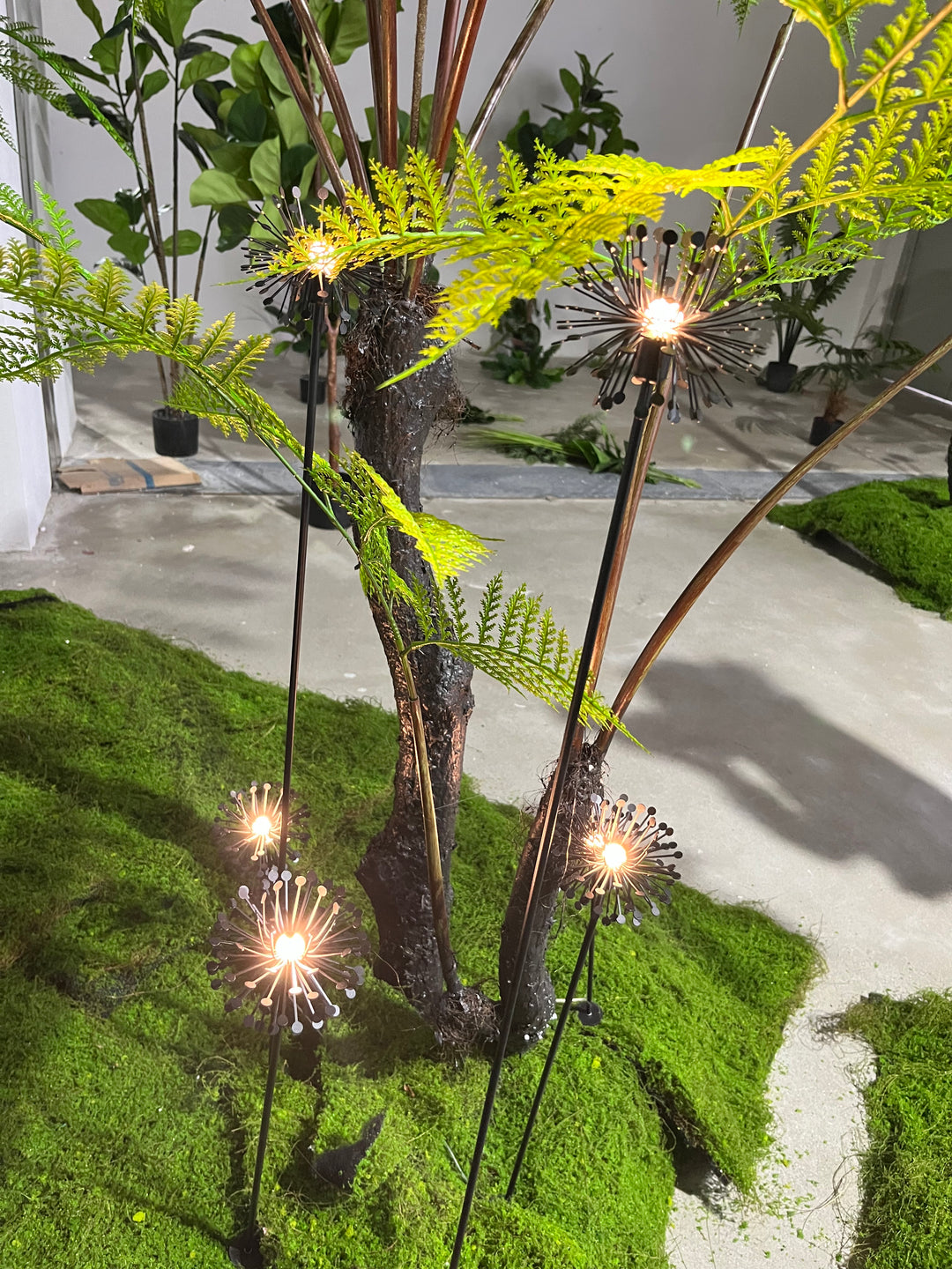 Decorative landscape spike lights integrated into garden planting and greenery