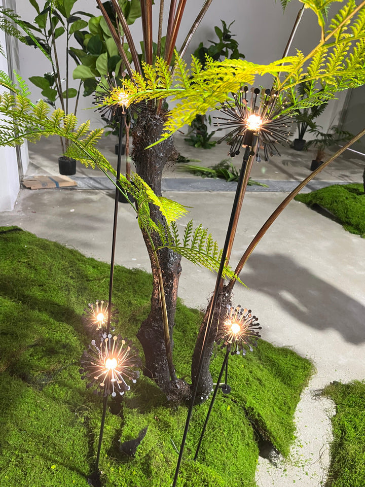 Decorative landscape spike lights integrated into garden planting and greenery