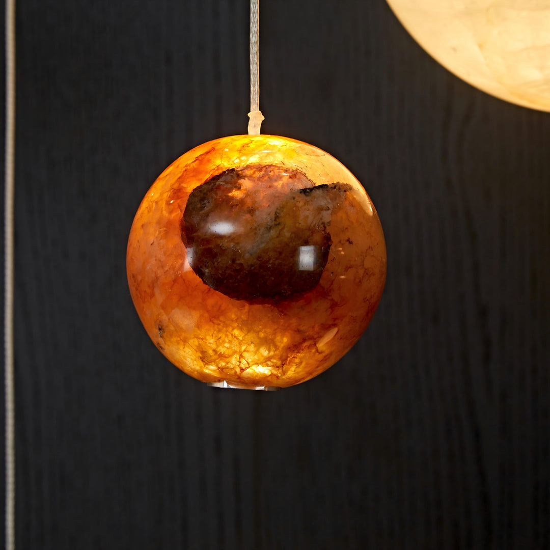 Honey natural agate pendant light highlighting organic veining, crystalline texture and soft architectural illumination.