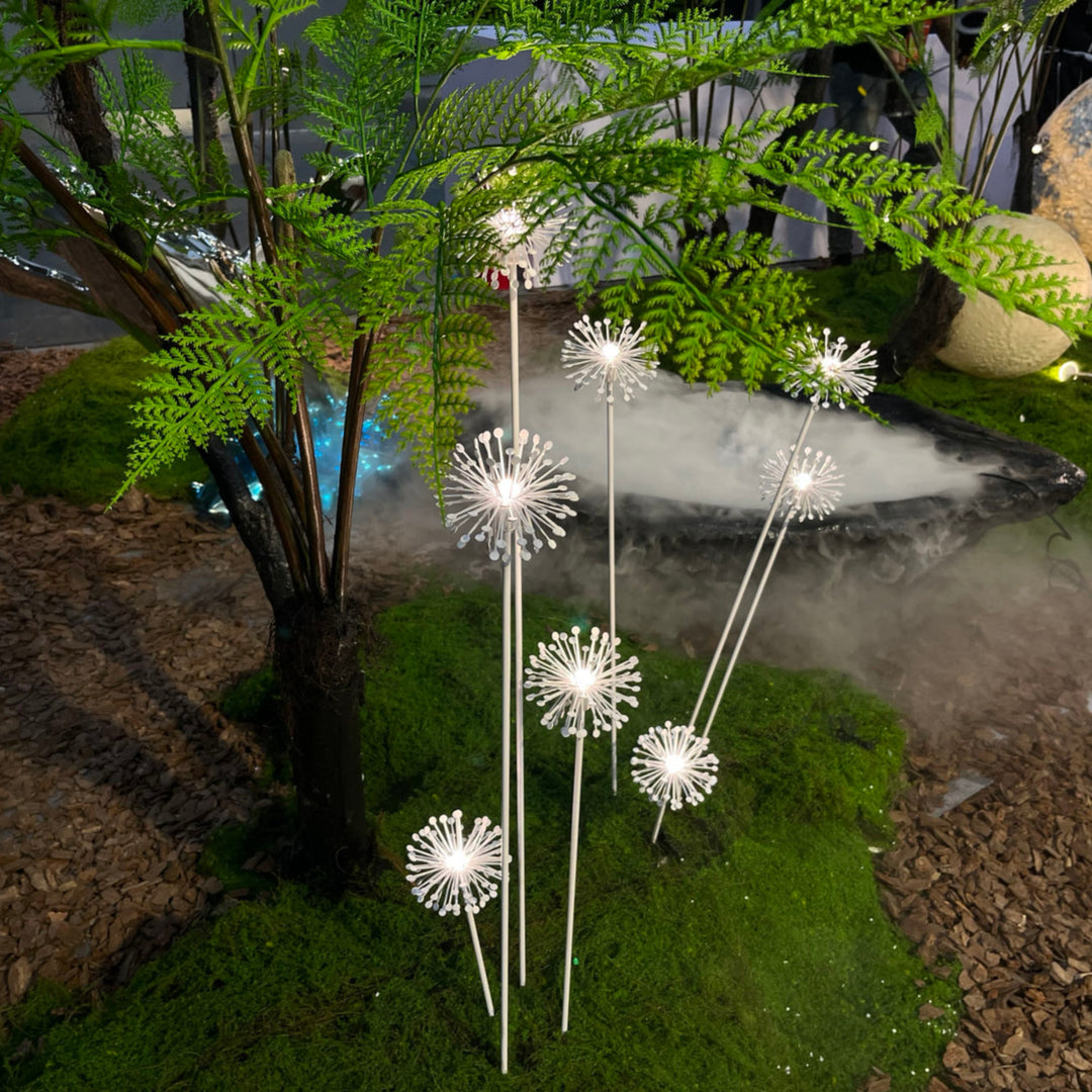 Decorative dandelion spike lights creating soft ambient lighting in a garden landscape setting