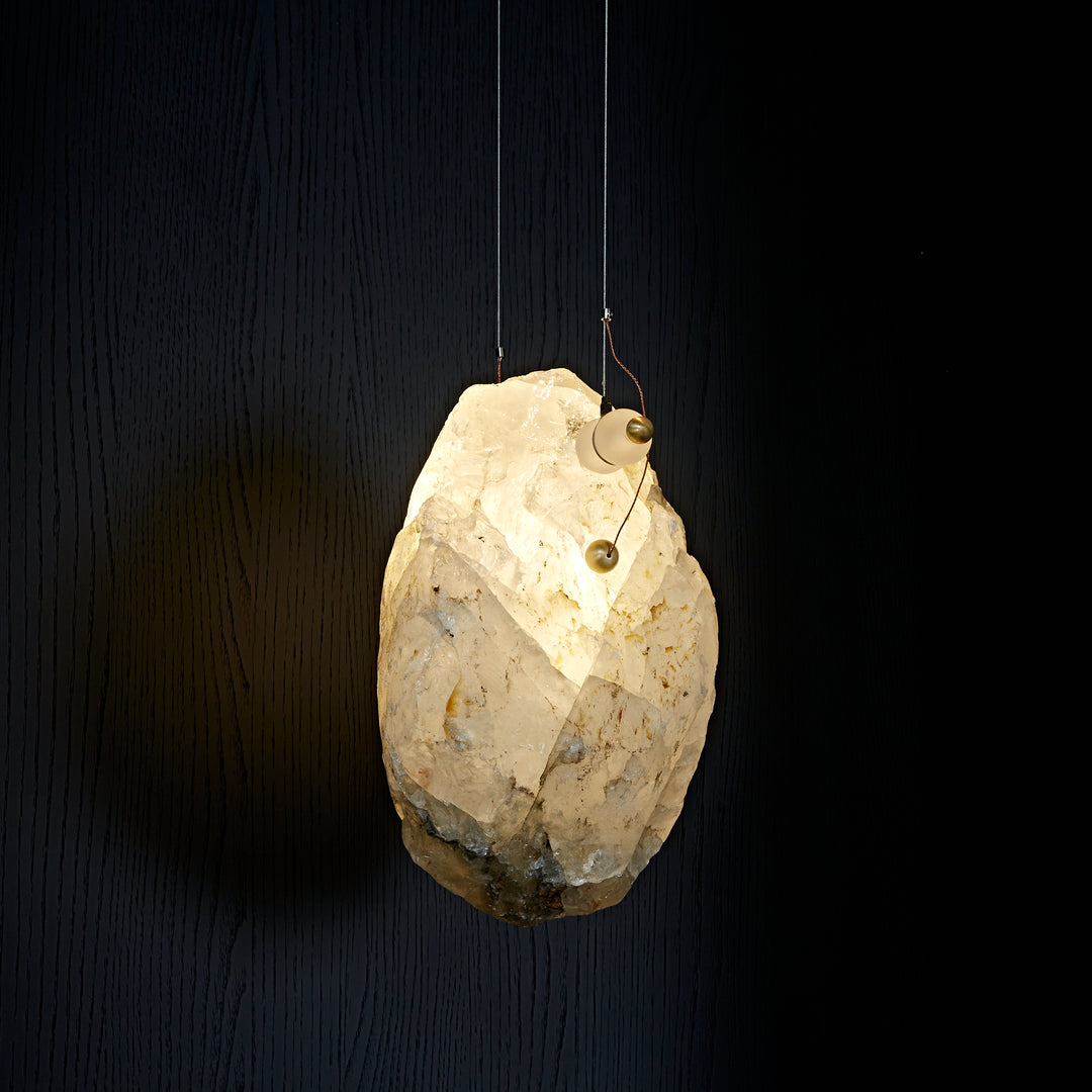 Large natural Brazilian crystal pendant light with integrated LED lighting and sculptural brass detailing.