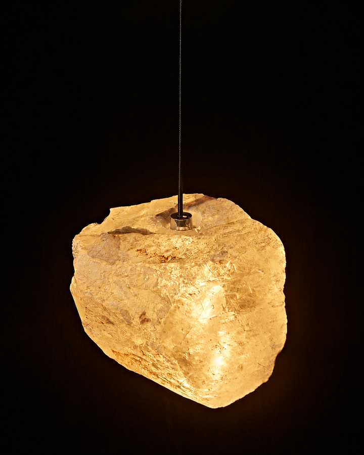 Close-up of an Aether Brazilian Natural Crystal Pendant Light showcasing authentic raw crystal texture, mineral inclusions and warm 3000K illumination.