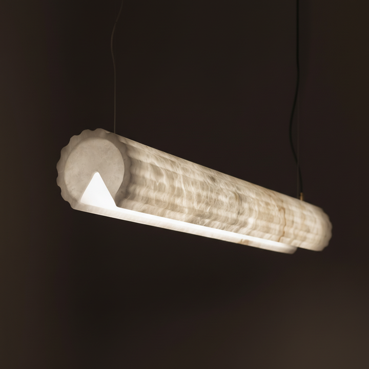 end view of Alabaster Flute LED linear pendant light in glowing Spanish alabaster for contemporary dining and kitchen lighting