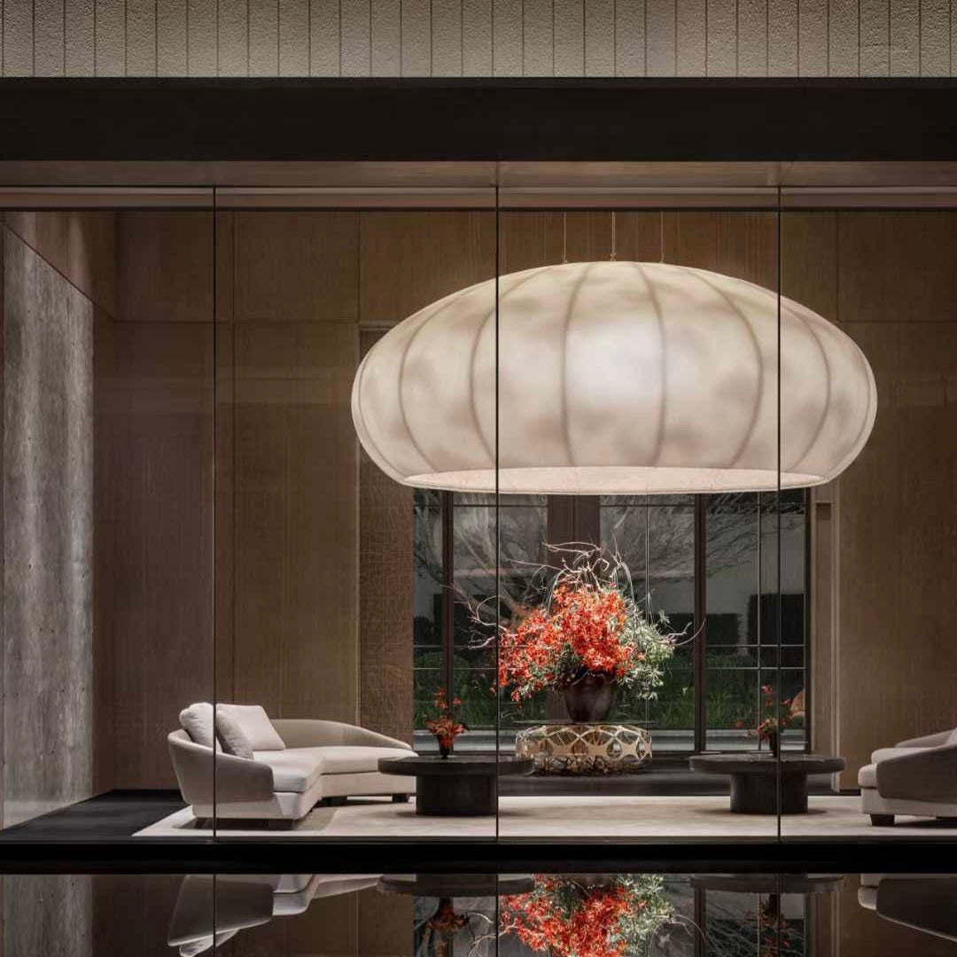 Lucretia Lighting Celestial Cloud bespoke pendant light illuminating a luxury lobby reception area with soft custom lighting and designer cloud-like form