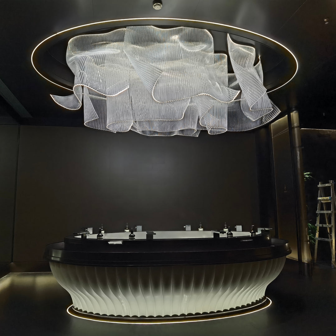 Lucretia Lighting bespoke infinity waves pendant light creating a sculptural luxury custom lighting feature in a grand hotel lobby