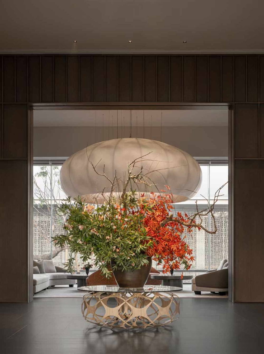 Lucretia Lighting Celestial Cloud bespoke pendant light creating elegant custom lighting above a floral lobby centerpiece in a luxury interior