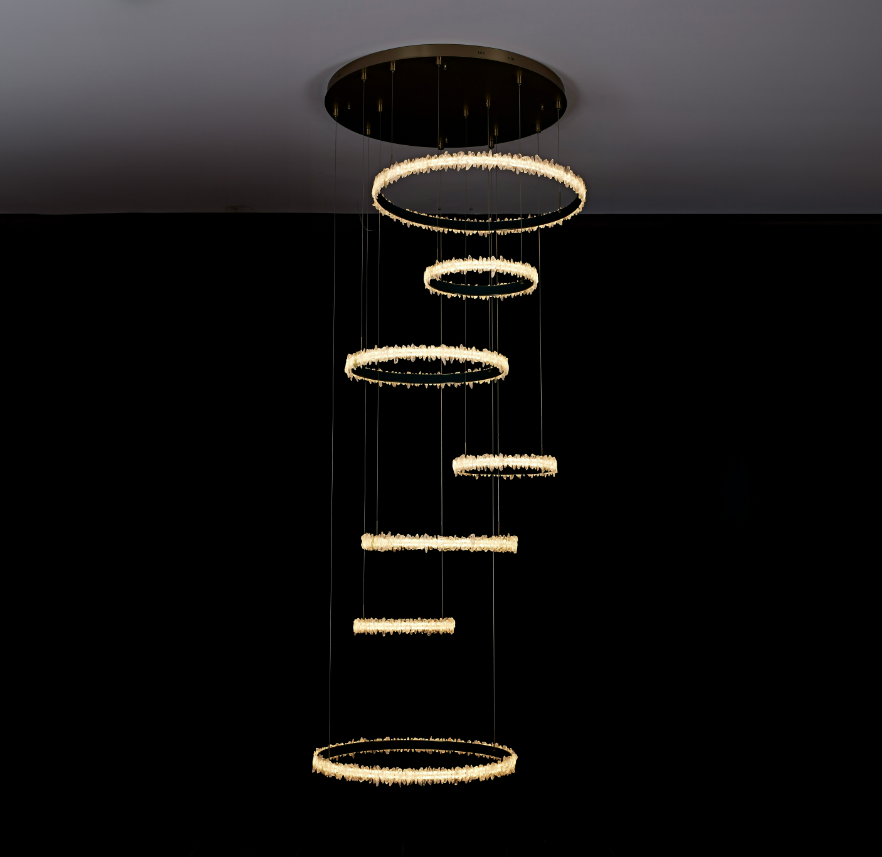 Lucretia Lighting Couro e Cristal bespoke crystal void pendant with cascading multi ring design for double height interiors and stair voids