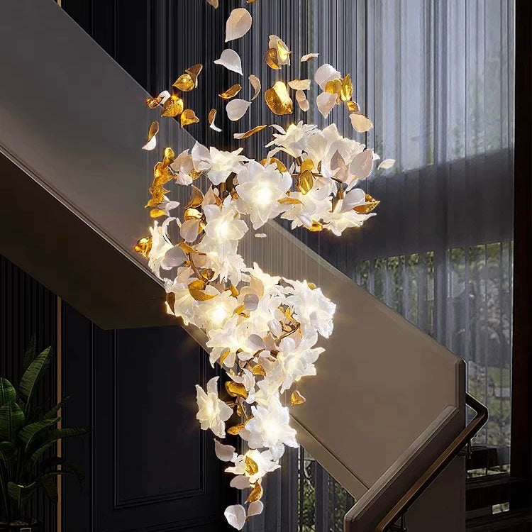 Lucretia Lighting Fall Floral bespoke sculptural leaf chandelier installed in a luxury stair void interior