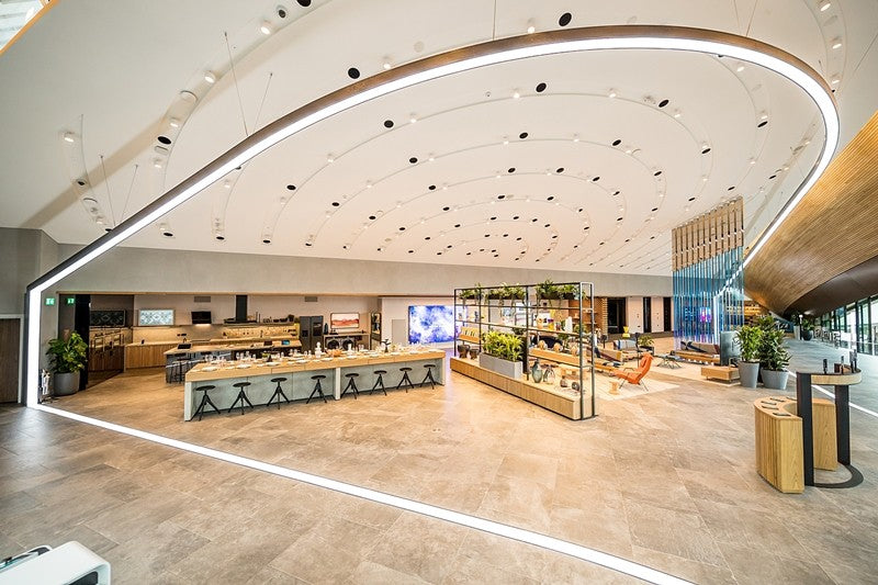 FlexCurve CX100 suspended curved LED linear lighting installed in a commercial interior for seamless ceiling illumination