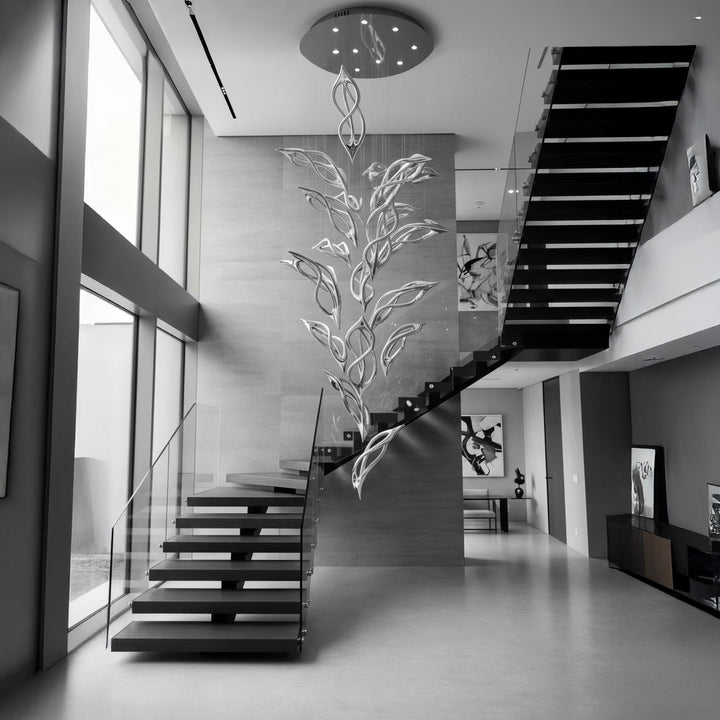 Lucretia Lighting Flora Cascade bespoke sculptural pendant light installed in a staircase void with cascading leaf elements for luxury double height interiors