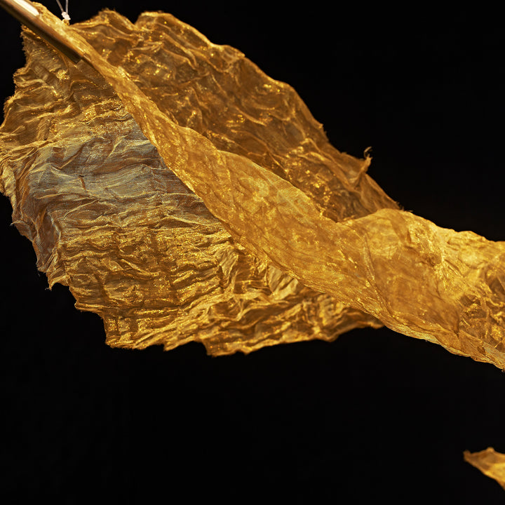 Close-up of handcrafted metallic woven leaf texture on the Gilded Leaf Pendant Light decorative sculpture.