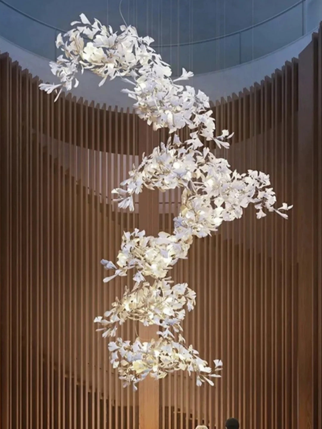 Lucretia Lighting Ginkgo Leaf bespoke pendant shown in a vertical sculptural leaf lighting installation