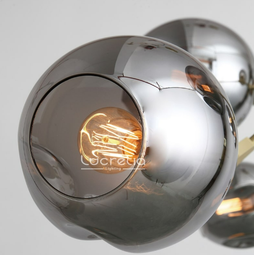 Close-up detail of the Glass Bubble Pendant 8 by Lucretia Lighting with smoke-tinted glass globe and warm filament glow
