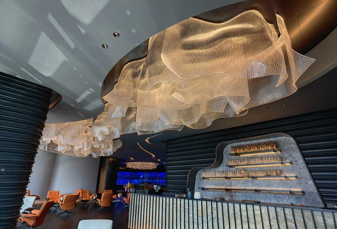 Lucretia Lighting infinity waves bespoke pendant light shown in a close-up upward view highlighting its sculptural wave-like custom lighting design