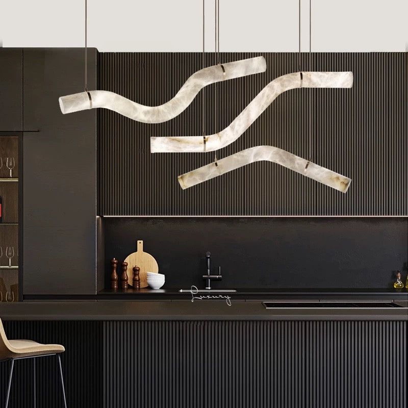 Lucretia Lighting Luma Flow sculptural alabaster pendant used as designer lighting above a modern bar and counter interior