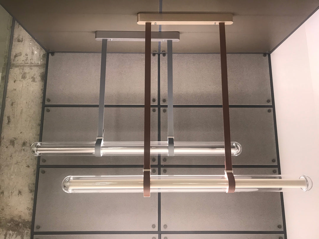 LumiTube linear pendant lighting installed in a contemporary commercial interior with layered modern illumination