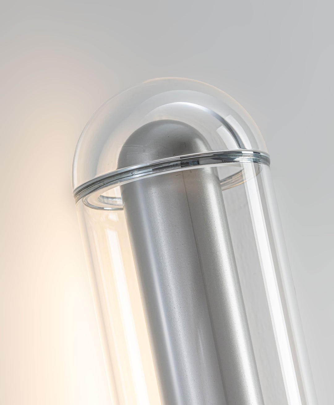 LumiTube Wall Light close-up showing hand-blown glass LED tube diffuser and brushed metal finish for modern wall lighting