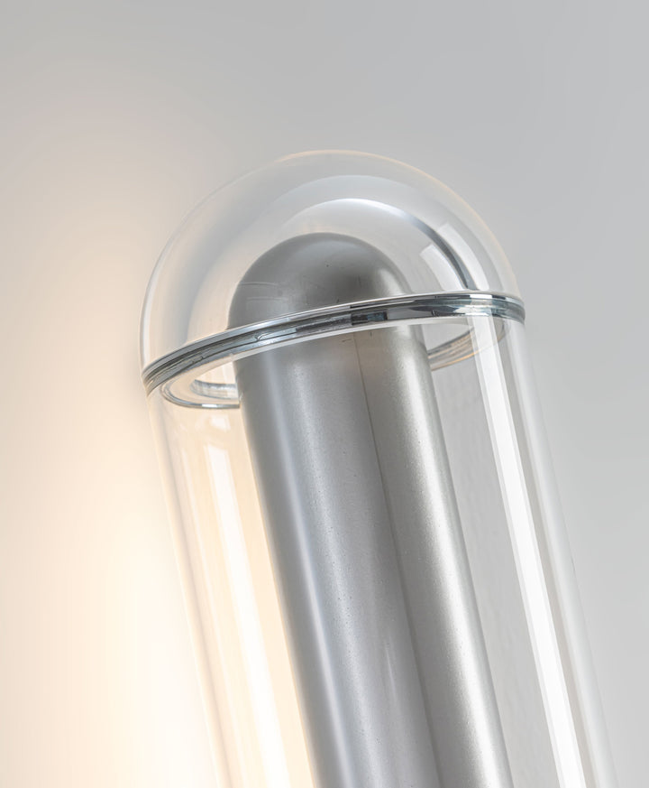 LumiTube Wall Light close-up showing hand-blown glass LED tube diffuser and brushed metal finish for modern wall lighting
