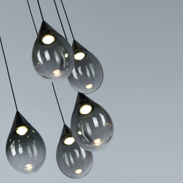 close up of Swedish hand blown raindrop glass pendants from the Norden Linear 10 design by Lucretia Lighting