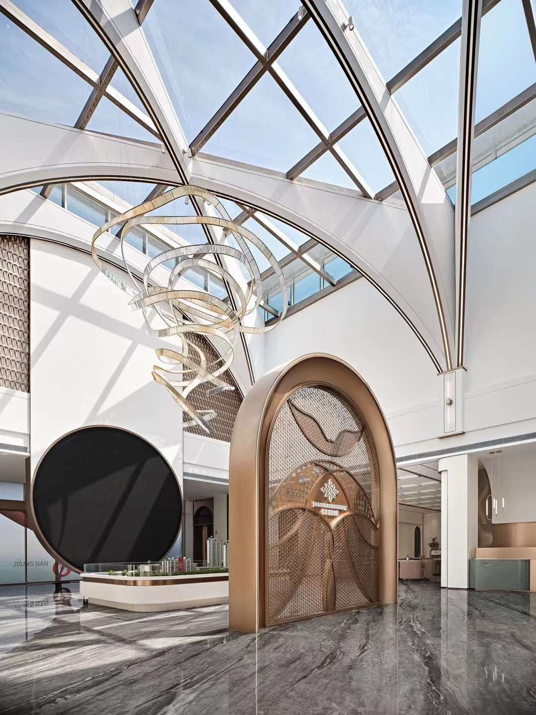 Lucretia Lighting Pharaoh Infinity bespoke lighting displayed in a commercial lobby, featuring a custom sculptural crystal chandelier with fluid architectural form