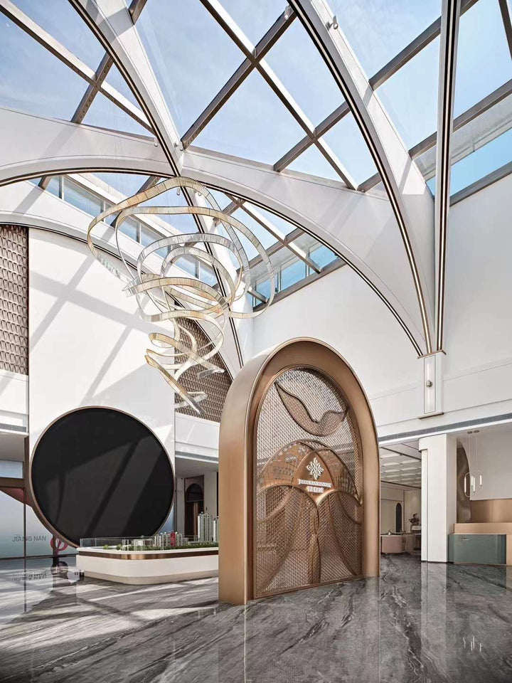 Lucretia Lighting Pharaoh Infinity bespoke lighting displayed in a commercial lobby, featuring a custom sculptural crystal chandelier with fluid architectural form