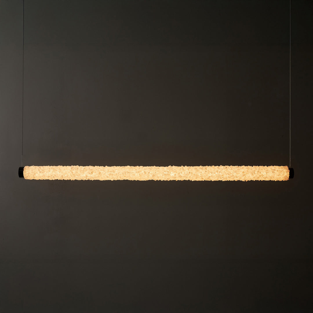 Serra Line crystal linear pendant light creating radiant architectural LED lighting above a long contemporary interior surface
