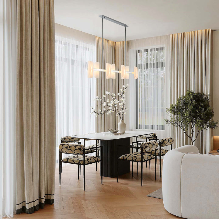 Lucretia Lighting Solvia 1200 linear pendant light installed above dining table with warm amber glass panels in modern interior