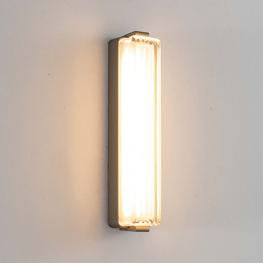 Striato LED wall light featuring ribbed glass panel and warm ambient lighting ideal for bedroom wall light and modern home lighting.