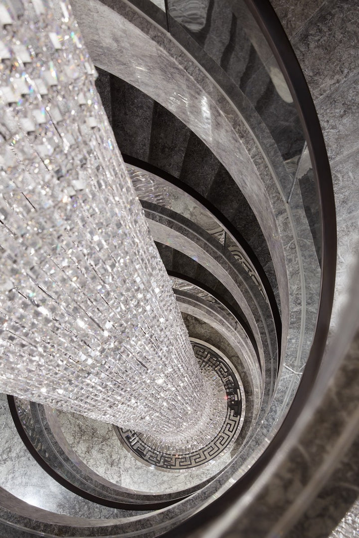 Lucretia Lighting Waterfall bespoke lighting spiral void crystal chandelier acting as an architectural feature in premium spaces