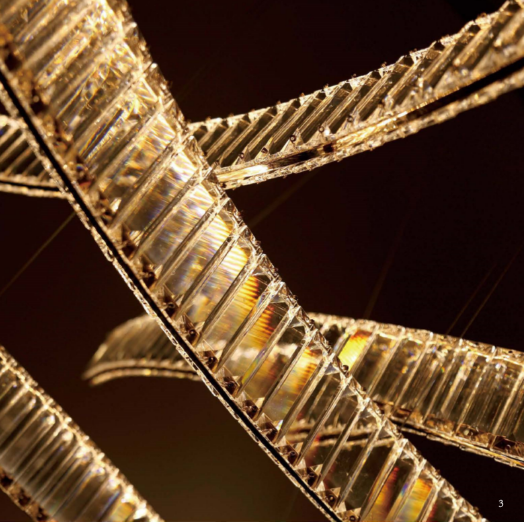 Close up detail of Lucretia Pharaoh Curve chandelier showing curved Egyptian crystal segments with precision LED lighting