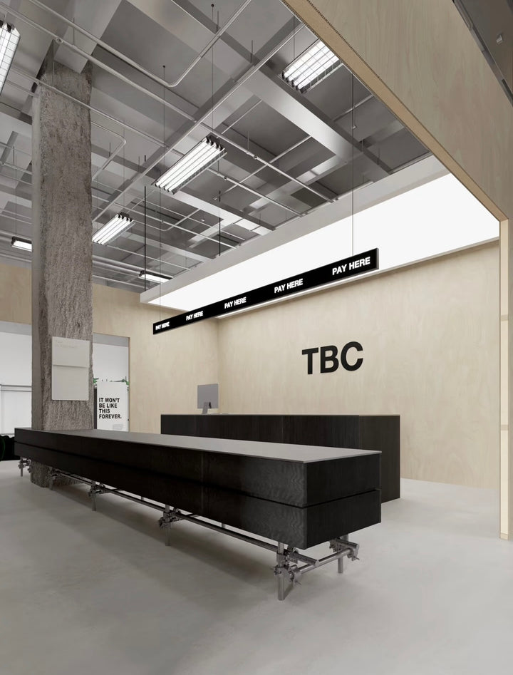 Lucretia retail LED backlit ceiling panel in an industrial-style shop interior.