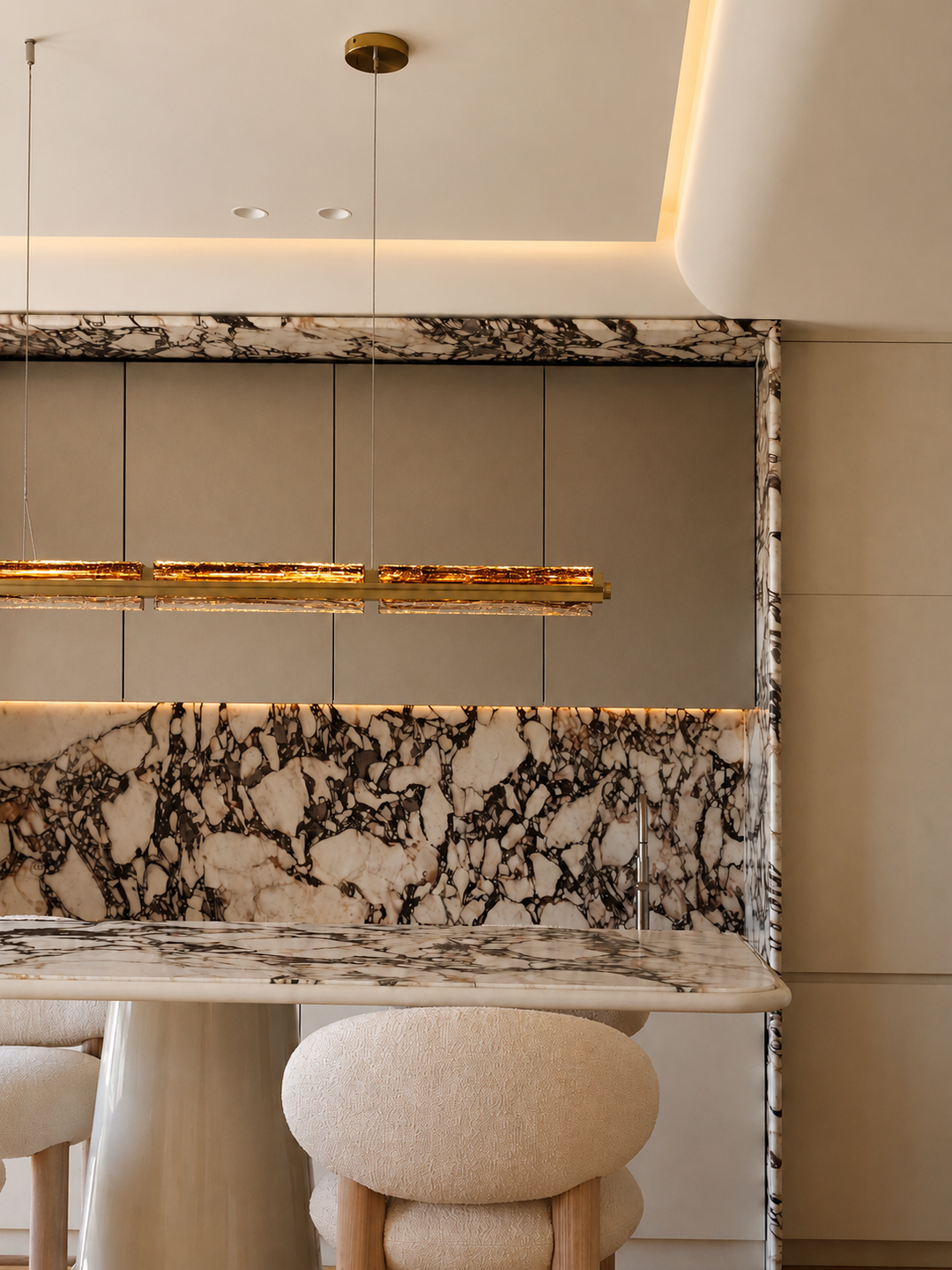 Luxury linear pendant lighting installed above a contemporary kitchen island.