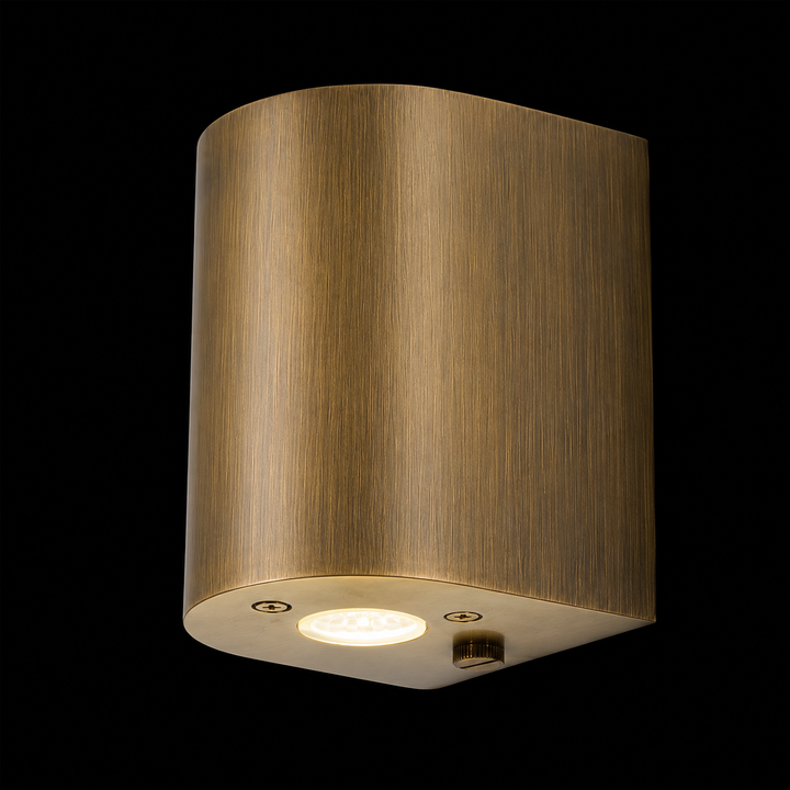 Solid brass cylinder outdoor wall light in antique brass finish featuring a handcrafted cylindrical design with integrated LED for contemporary outdoor architecture.