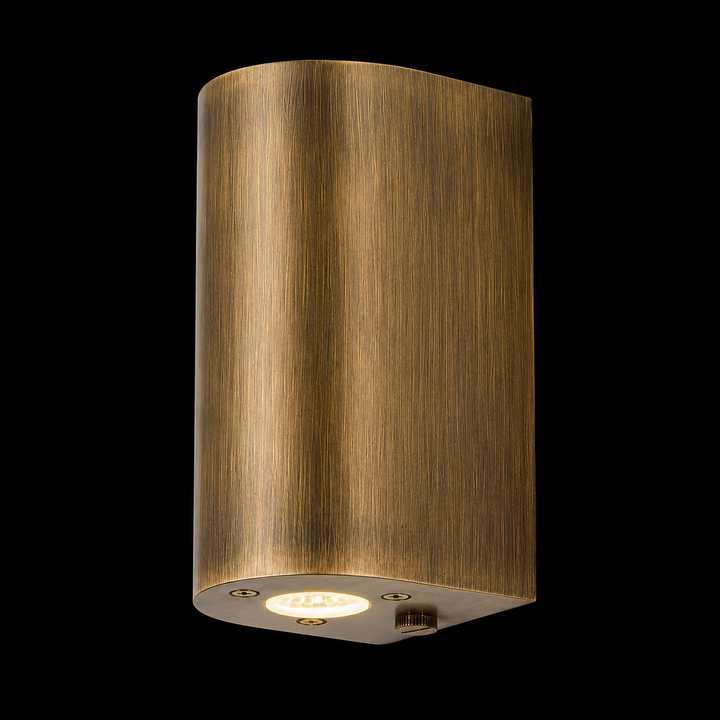 Handcrafted solid brass cylinder outdoor wall light in antique brass finish with integrated LED for luxury exterior architecture.