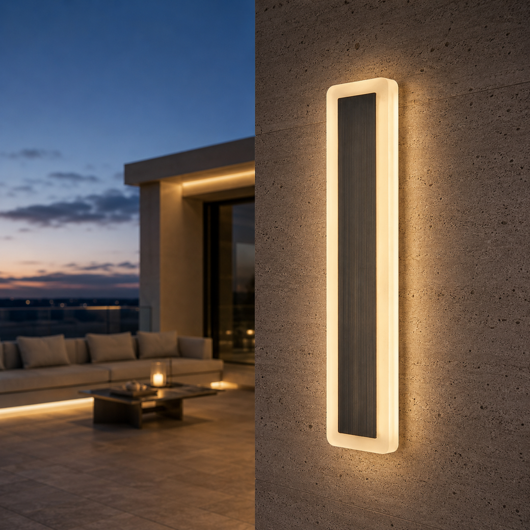 Solid brass modern outdoor wall light with illuminated acrylic frame mounted on a contemporary exterior wall, creating warm architectural lighting for luxury homes.