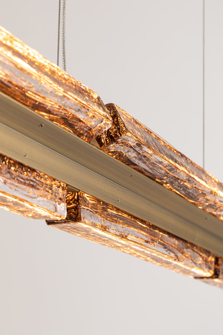 Close-up of smoked amber textured glass illuminated in the Running Water Horizon collection.