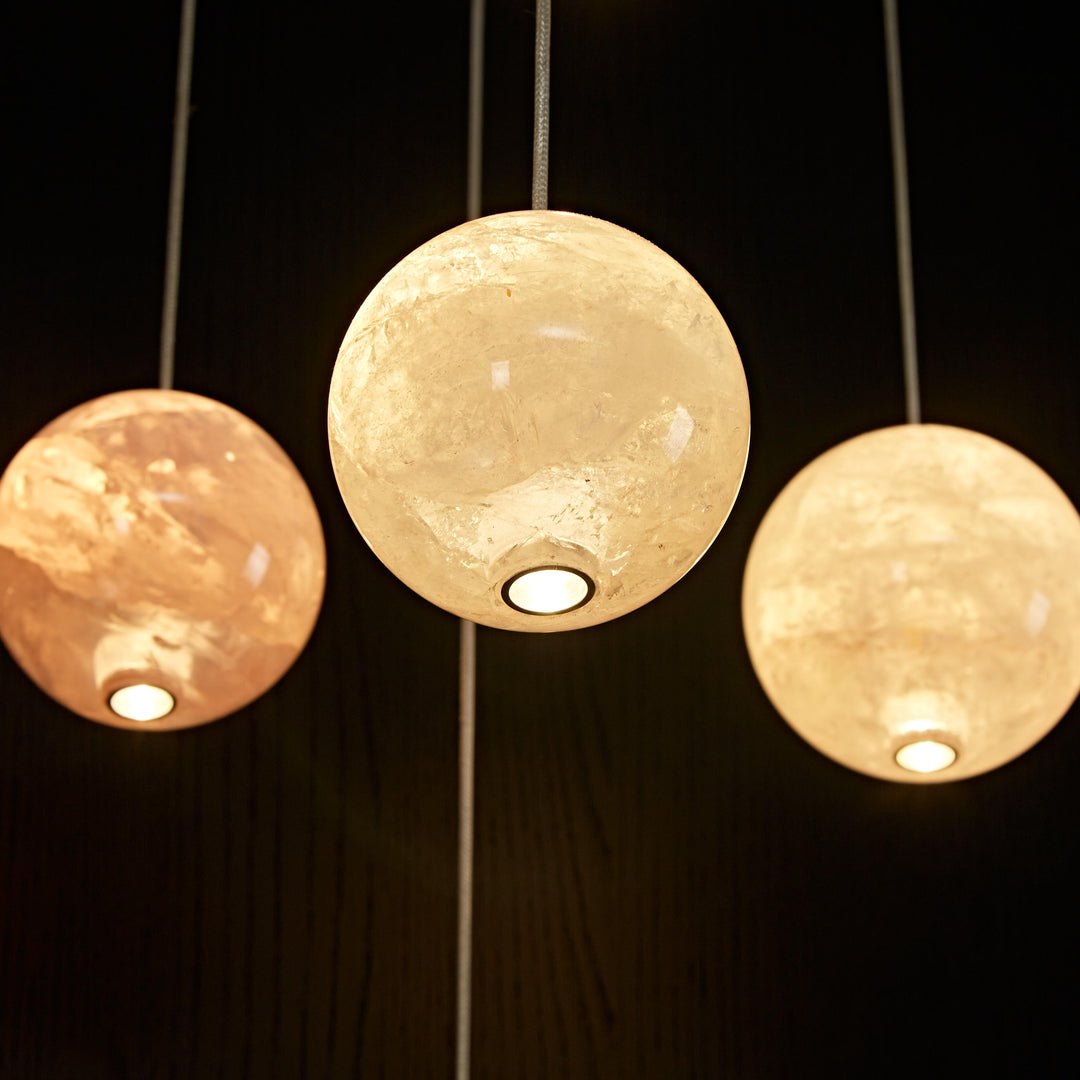 Cluster of white natural agate pendant lights creating a sculptural luxury lighting installation.
