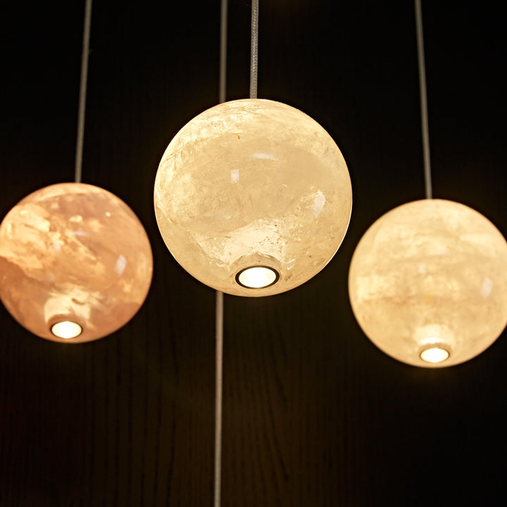 Cluster of white natural agate pendant lights creating a sculptural luxury lighting installation.