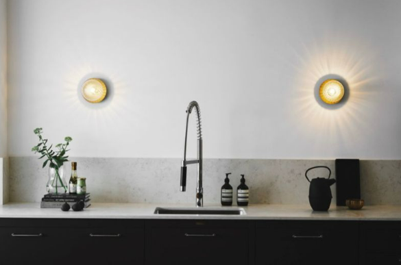 pair of glass sphere wall lamps on kitchen wall above benchtop creating warm ambient kitchen lighting suitable for modern indoor wall lighting and home décor