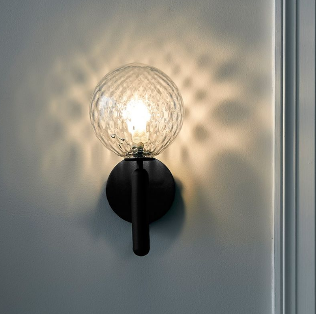 textured glass sphere wall light casting sparkling ambient reflections suitable for bedroom bedside lighting bathroom vanity wall light and modern interior spaces