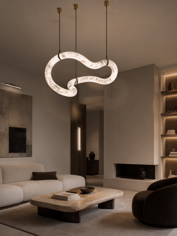 Luxury Spanish alabaster organic pendant light illuminating a contemporary living room with bespoke architectural lighting.