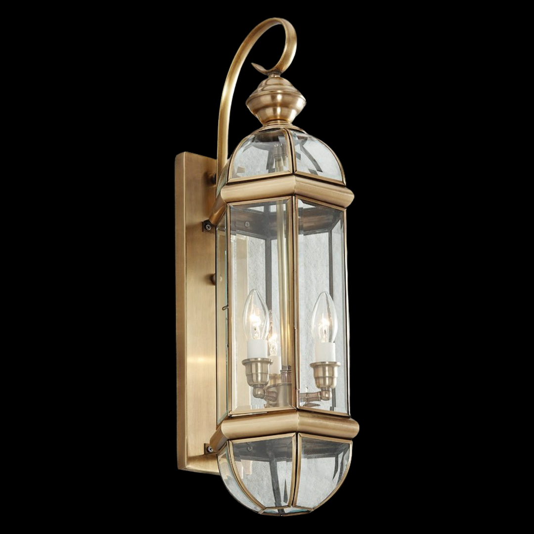 Marseille 660 brass outdoor wall lantern with elongated clear-glass panels and a classic curved arm design for exterior lighting.